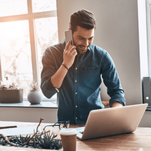 business person using laptop and phone for conferencing