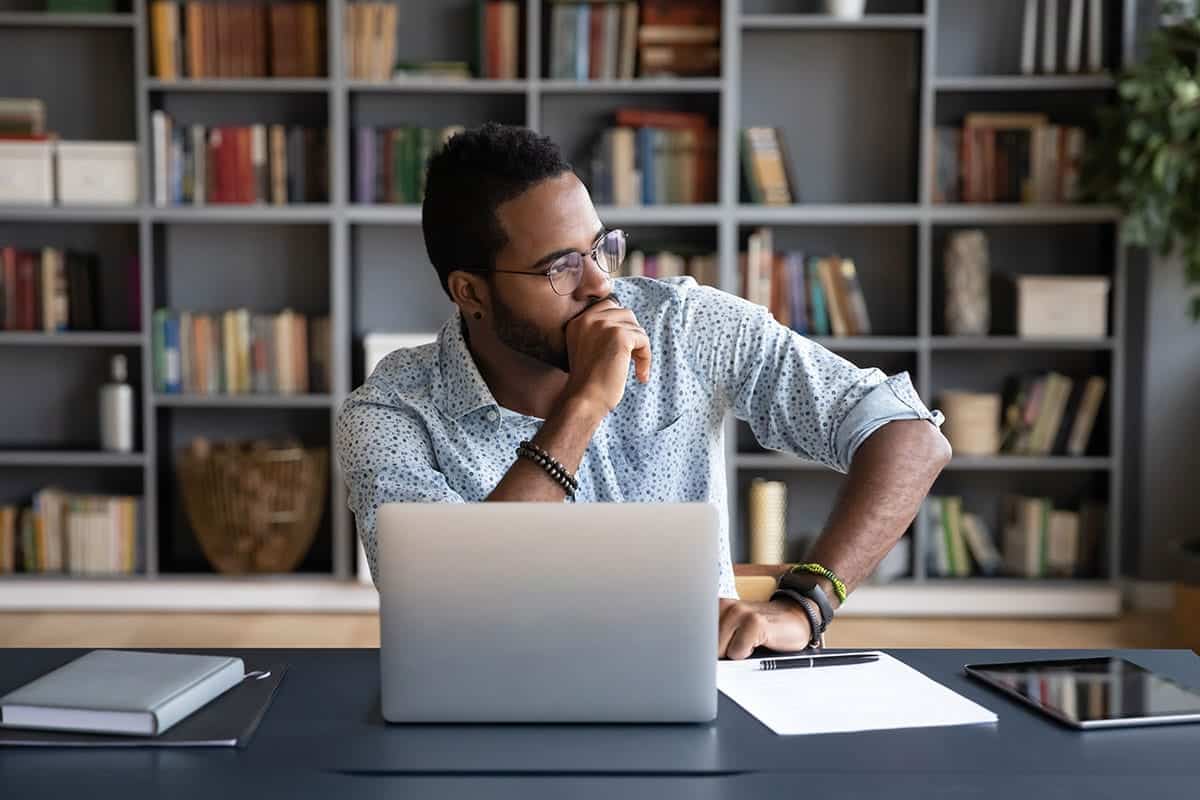 businessman sitting at workplace thinking over problem